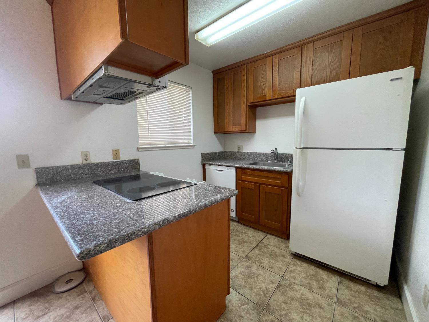 a kitchen with a sink a stove a refrigerator and a sink