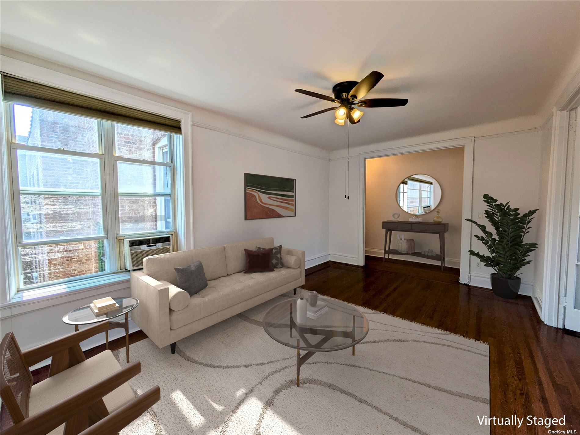 a living room with furniture a potted plant and a large window