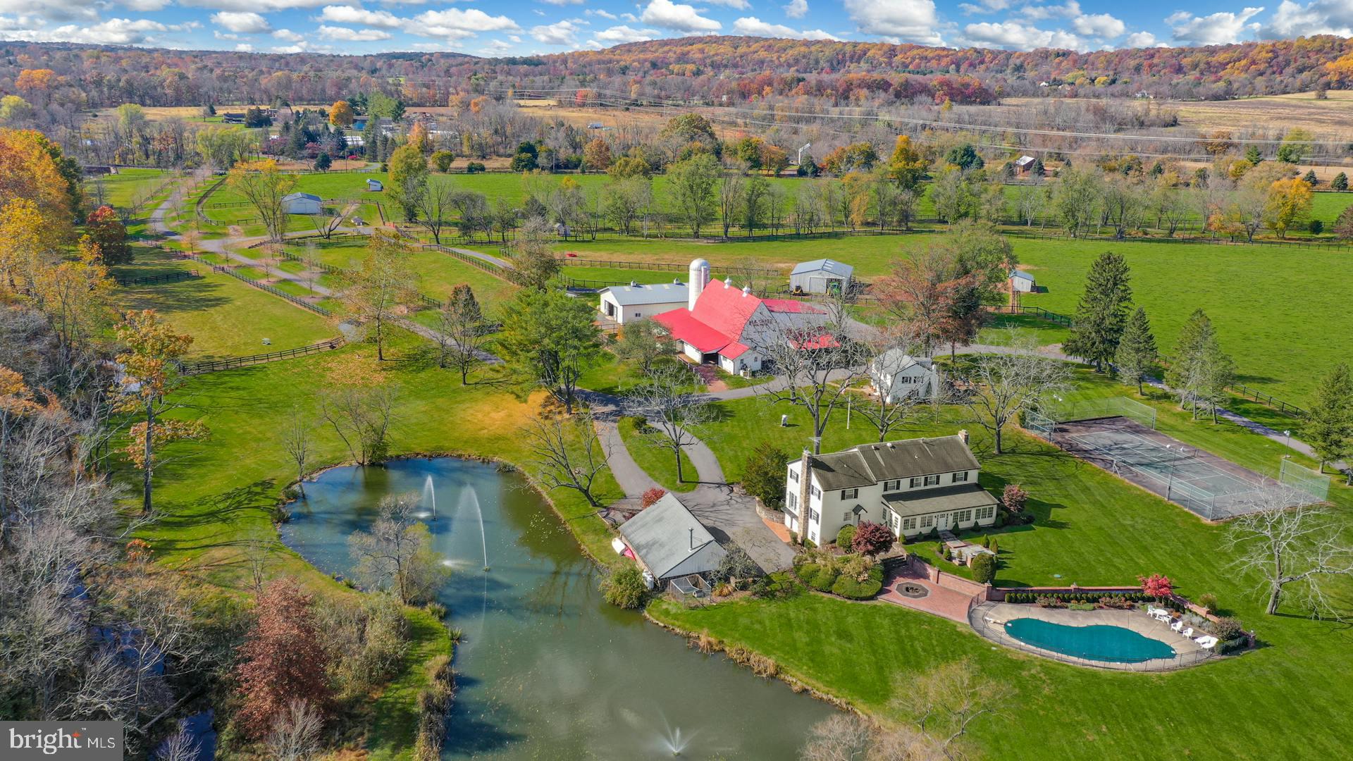 an aerial view of a house with a garden and lake view