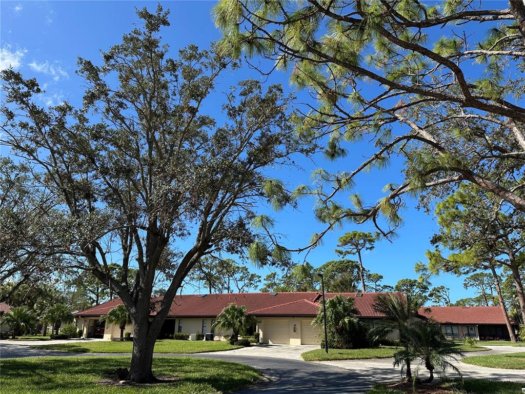 a front view of a building with trees