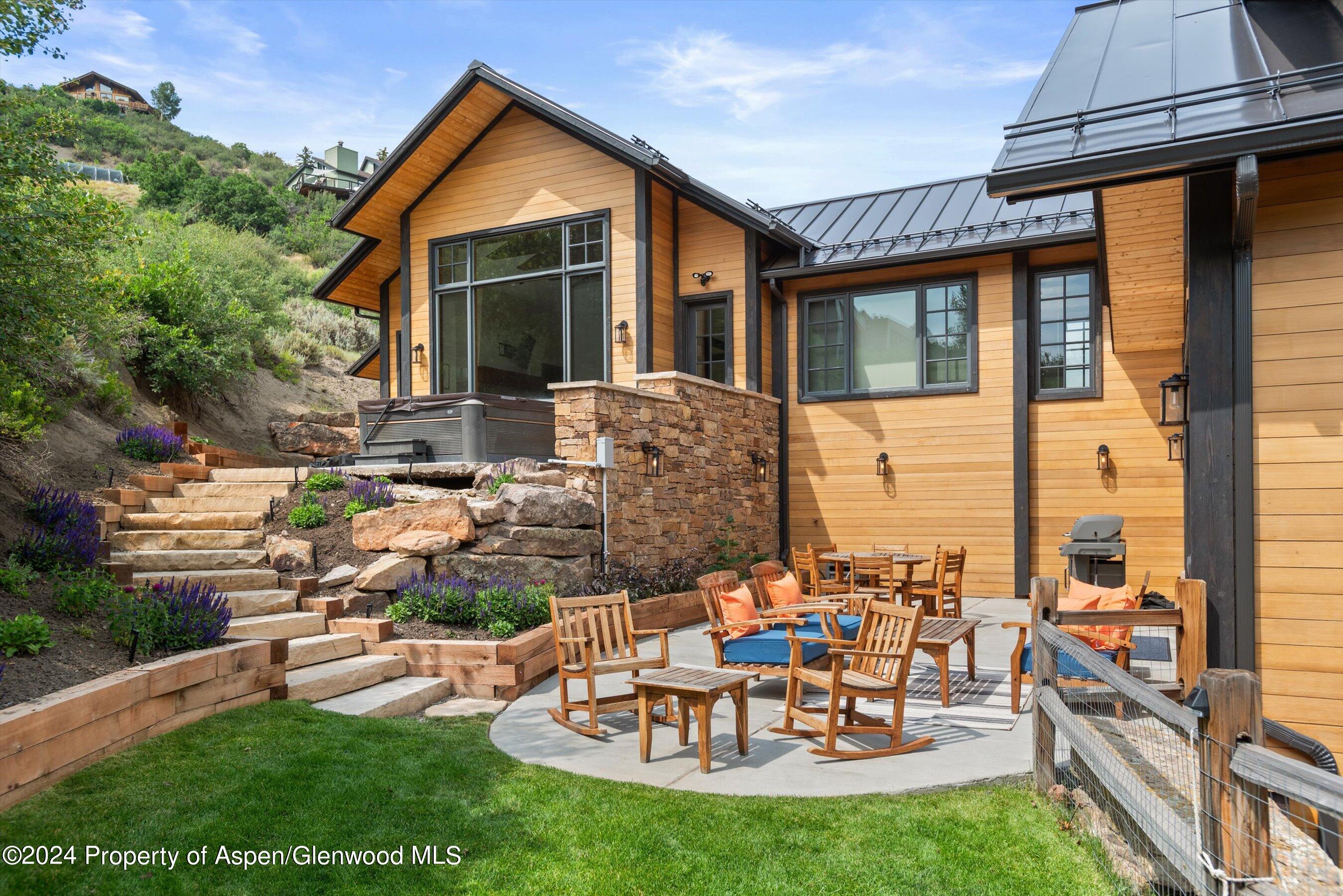 a view of a house with backyard sitting area and garden