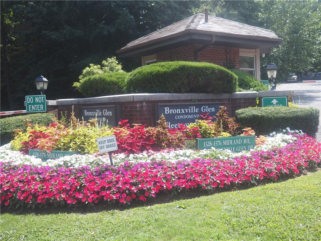 a street view with flower garden and swimming pool