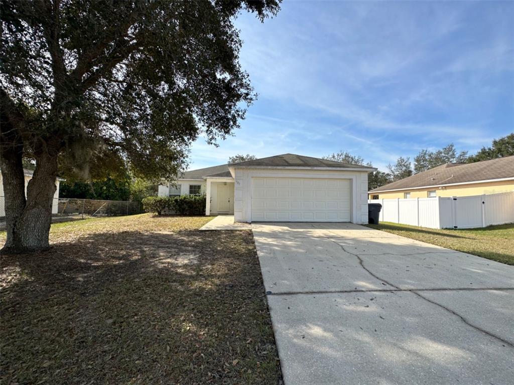 a view of a house with a yard and garage