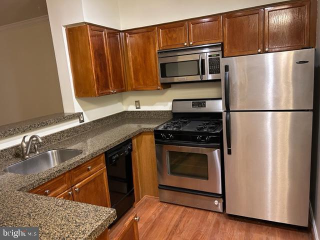 a kitchen with granite countertop a refrigerator stove and microwave