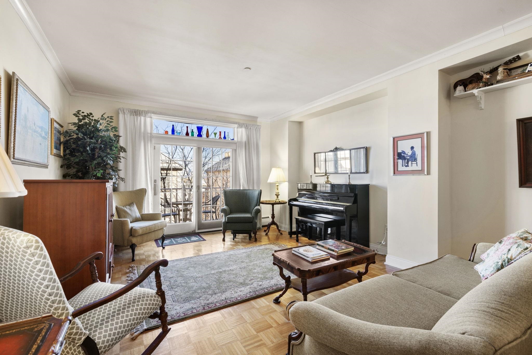 a living room with furniture a rug and a fireplace