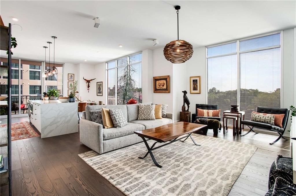 a living room with furniture a window and a clock