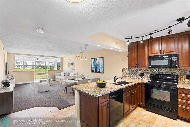 a kitchen with a stove a sink and a refrigerator