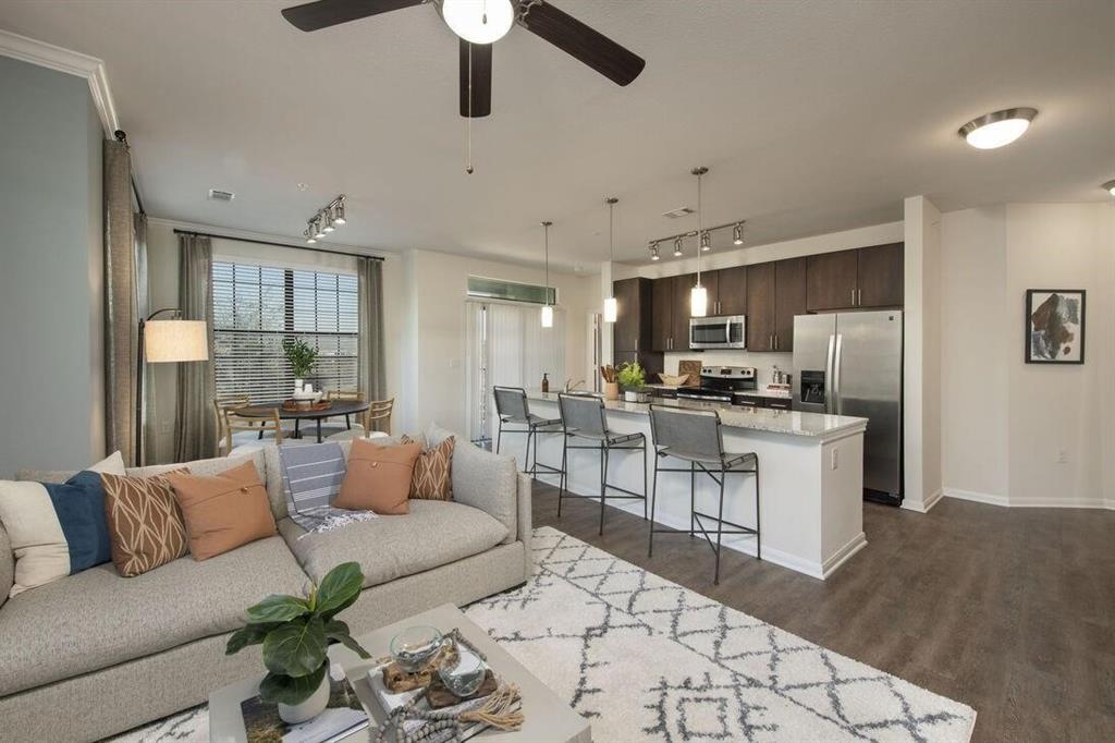 a living room with furniture and kitchen view