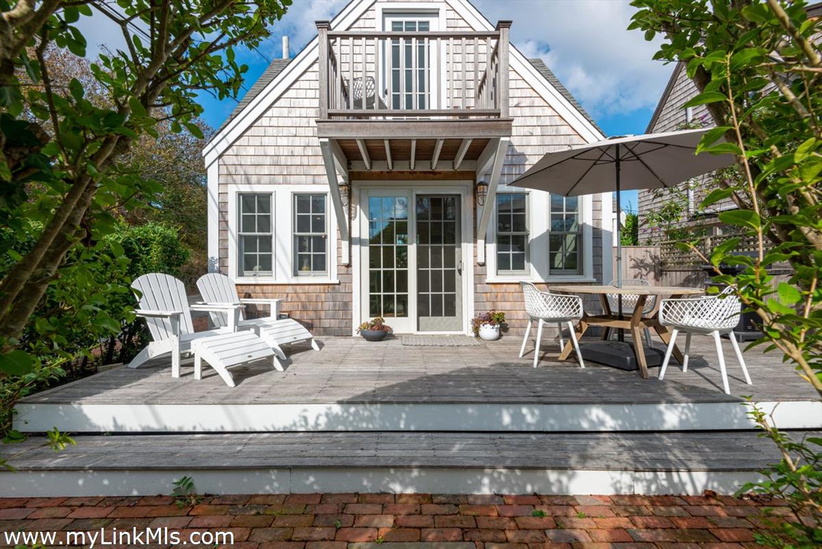 a view of a house with a yard and sitting area