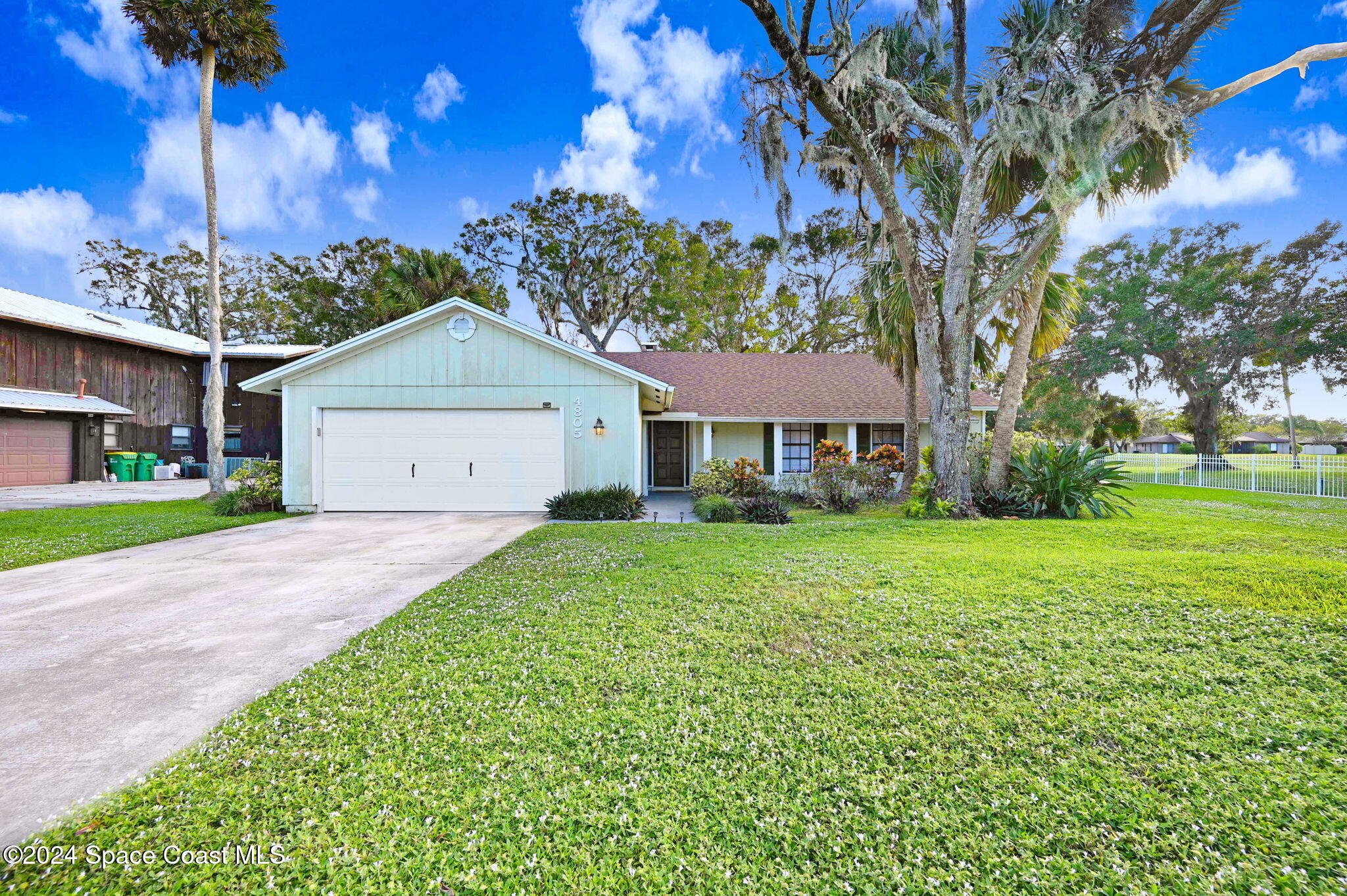 a front view of house with yard and green space