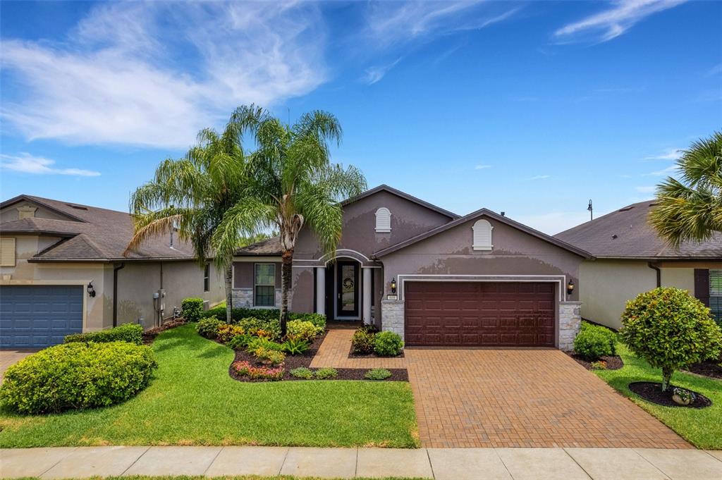 a front view of a house with a yard and garage