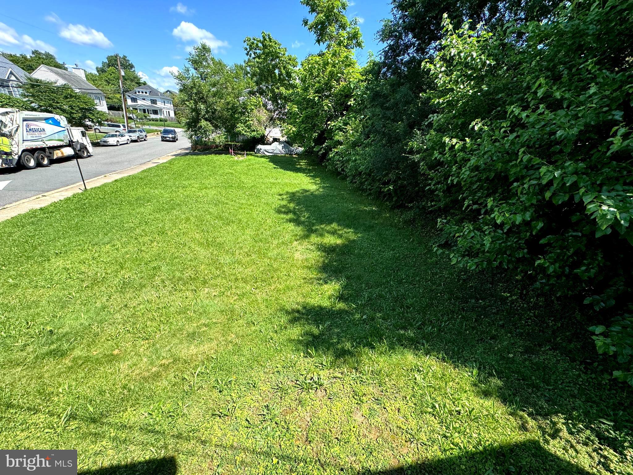 a view of yard with swimming pool and green space