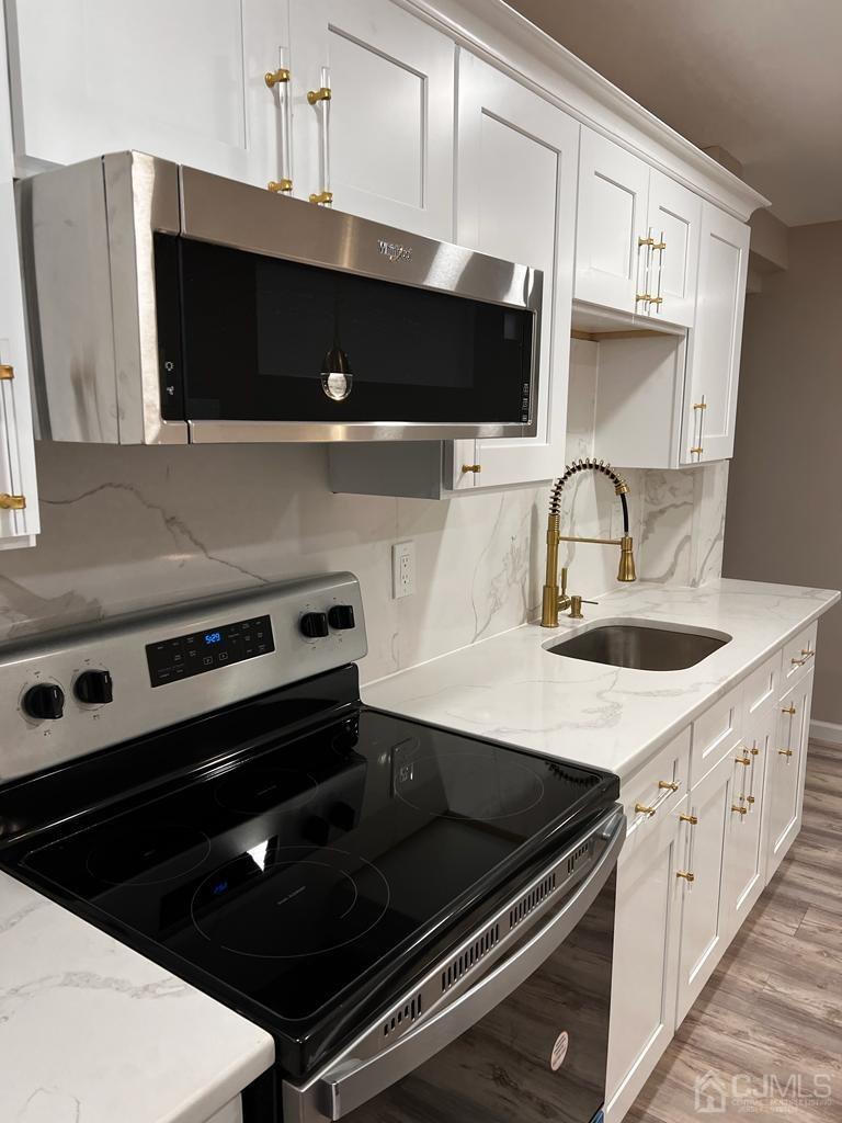 a kitchen with a stove microwave and sink