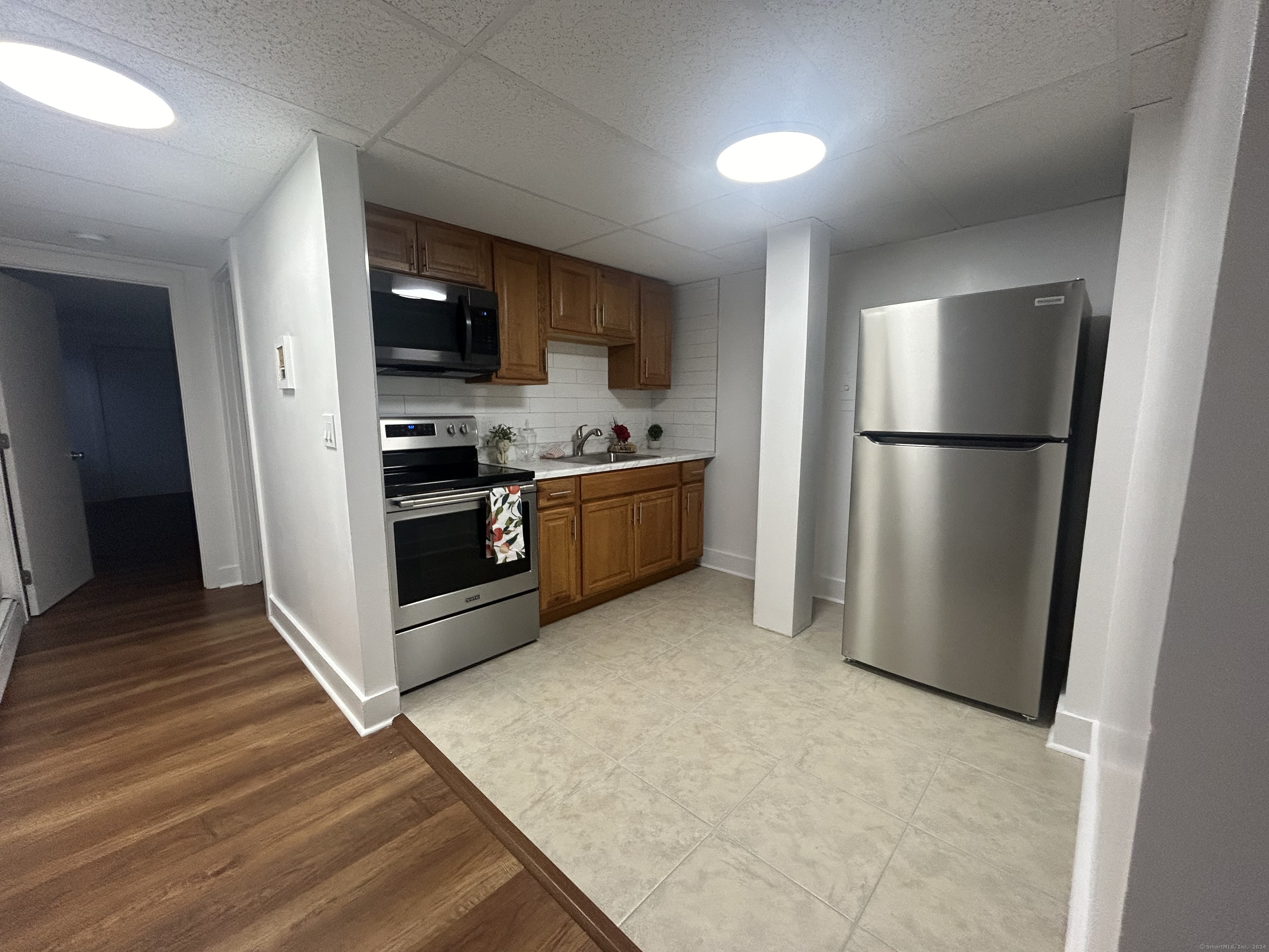 a kitchen with stainless steel appliances a refrigerator and a stove