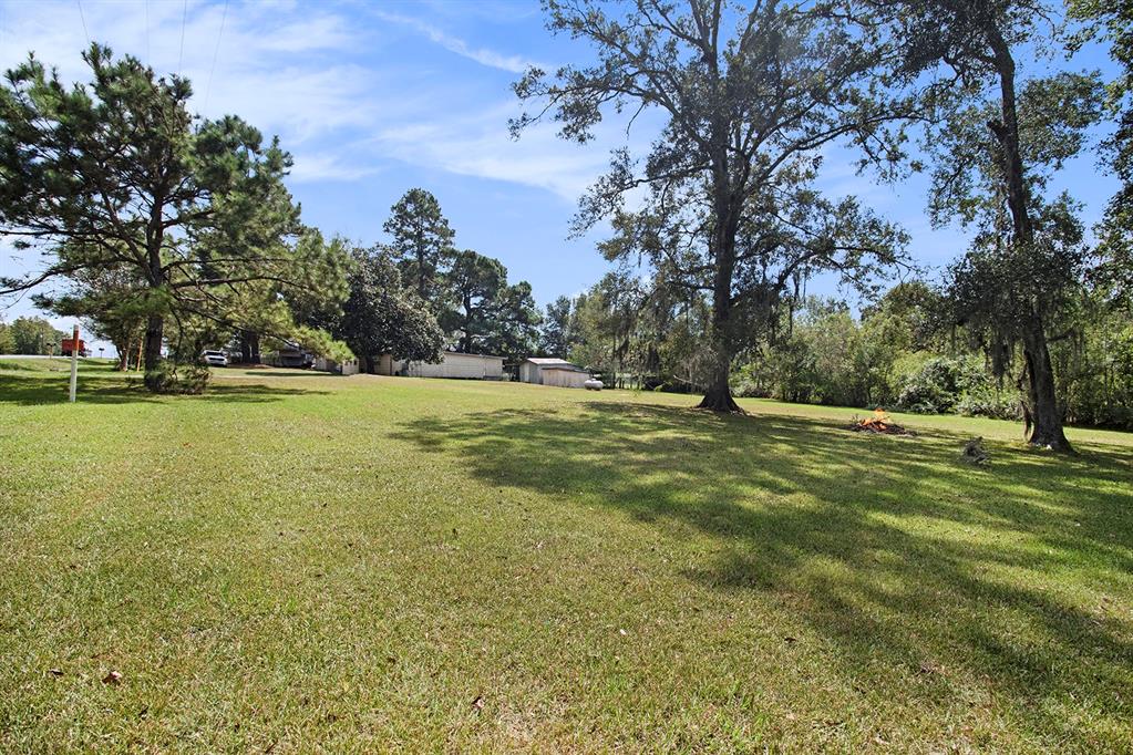 a view of a field with trees around