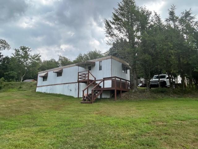 a view of a house with backyard porch and sitting area