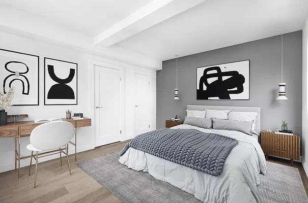 a bedroom with a bed and painting on the wall