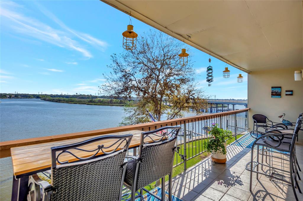 a view of a chairs and table on the balcony