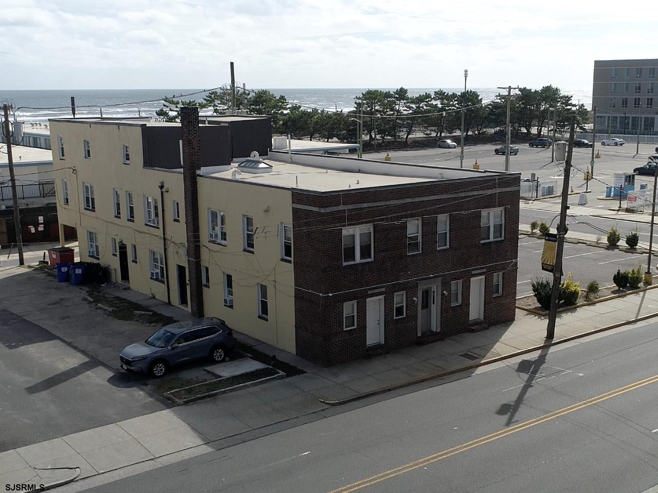 a view of a street with a building and trees in the background