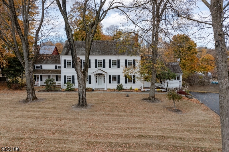 a view of a house with a yard and sitting area