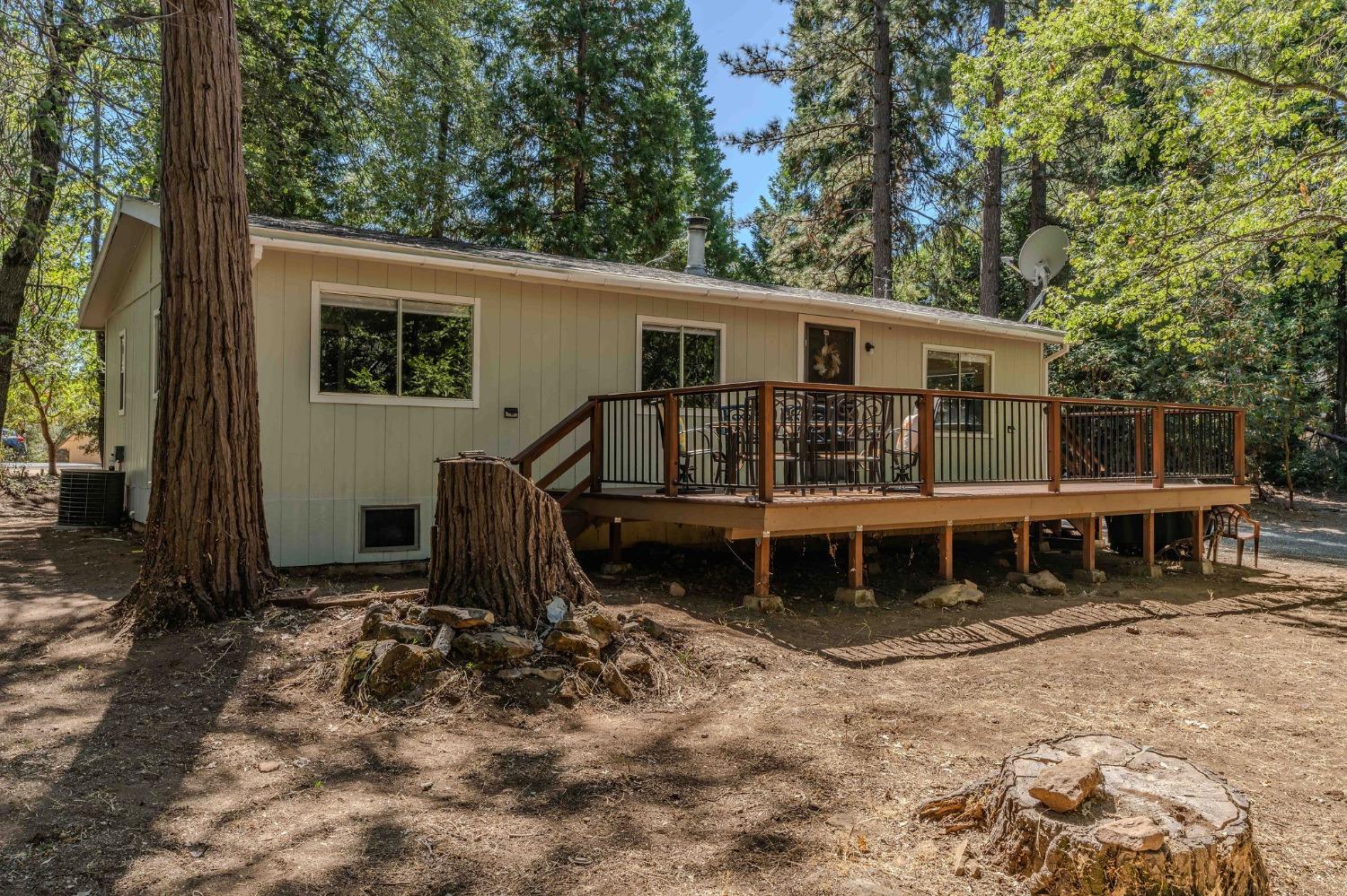 a view of a house with a yard and wooden fence