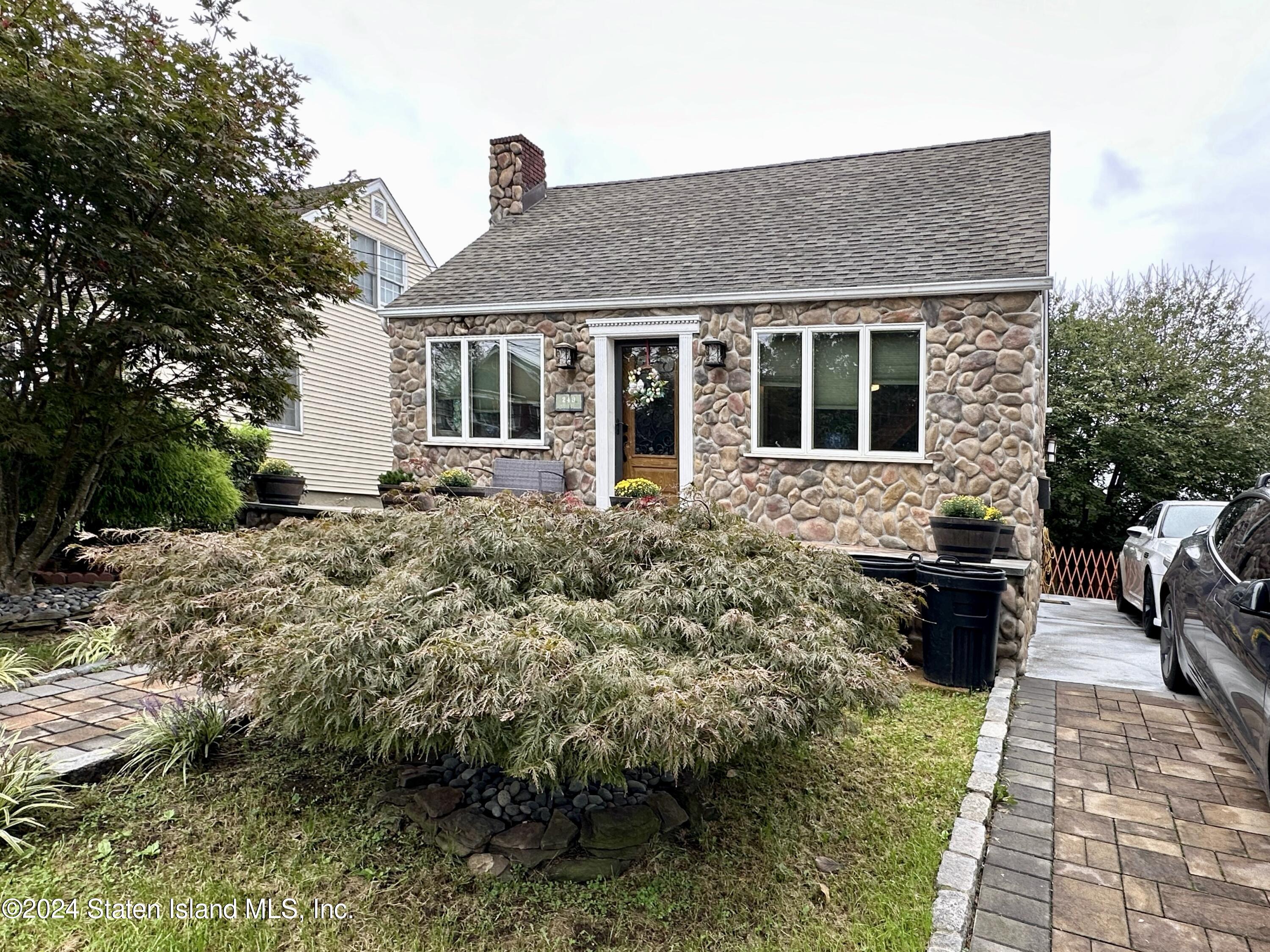 a front view of a house with a garden