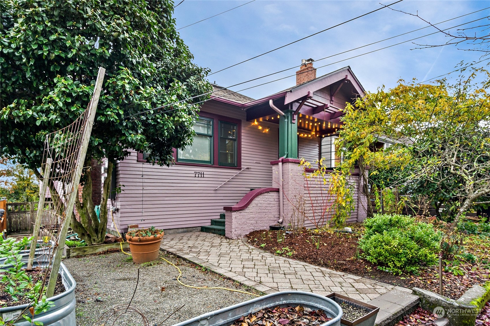 a front view of a house with a garden