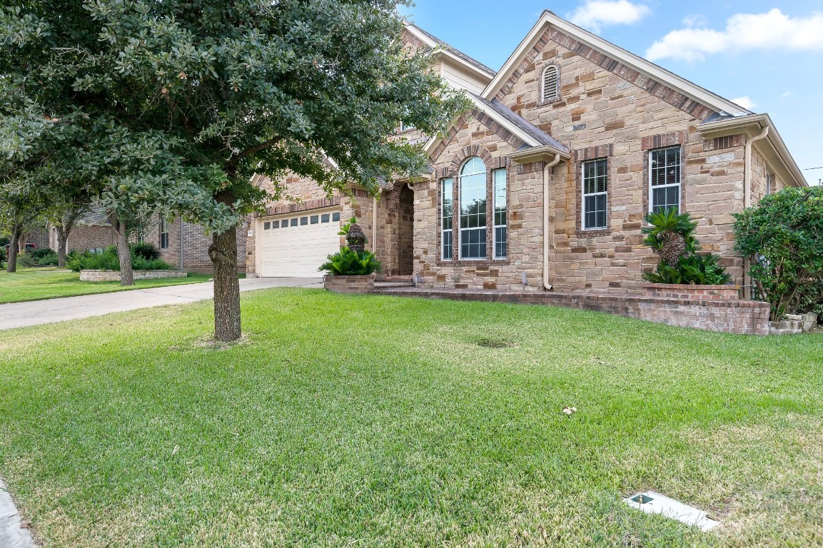 a front view of house with yard and green space