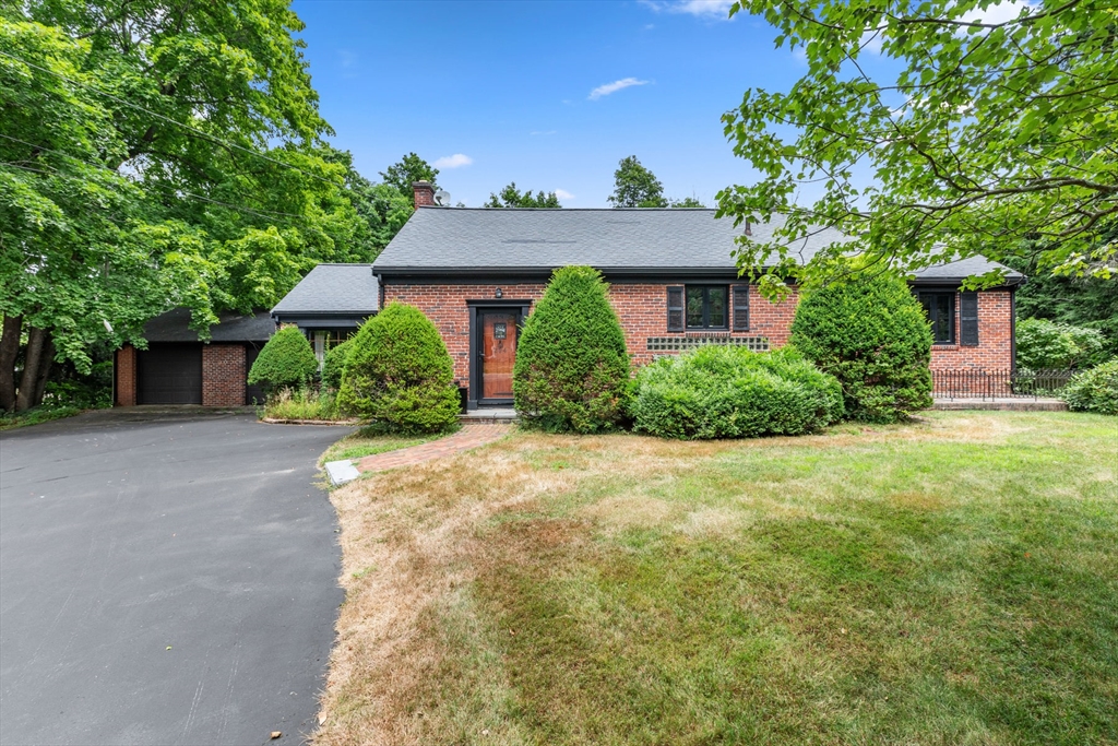 a front view of a house with a yard and a garage