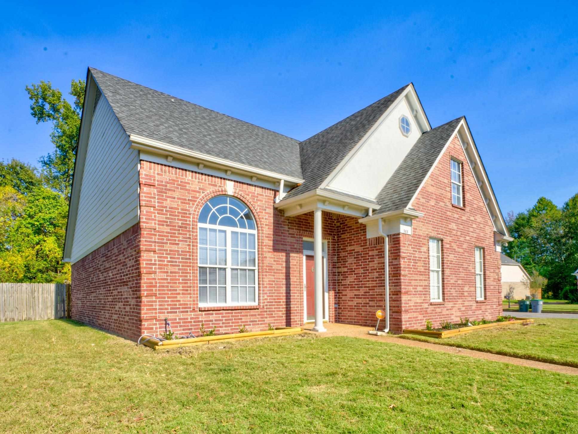 a front view of a house with a yard