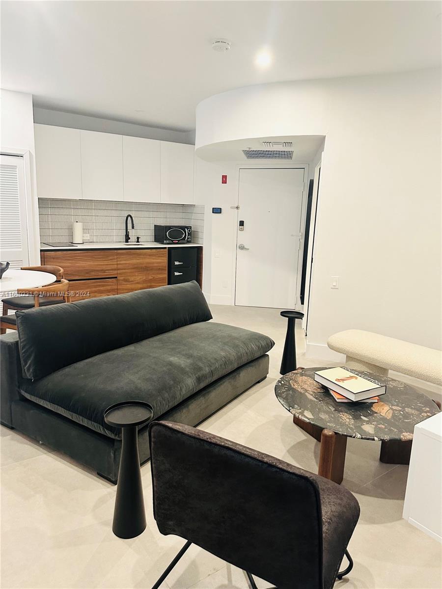 a living room with a table and a stove