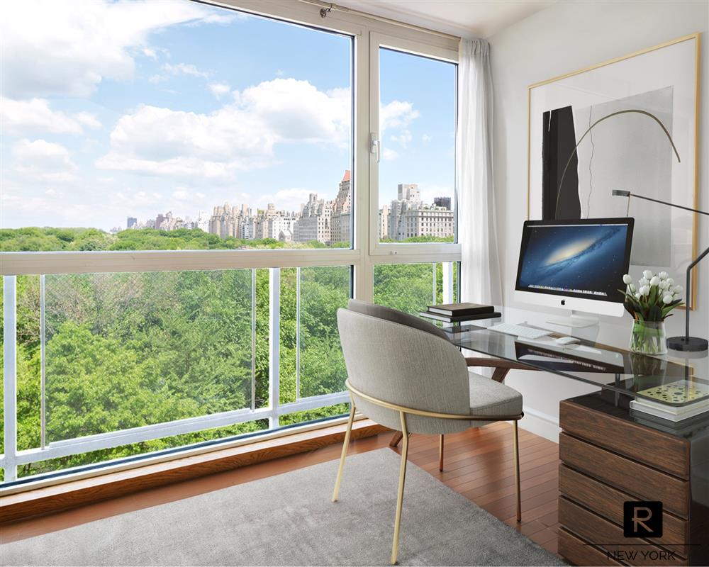 a living room with furniture and a floor to ceiling window