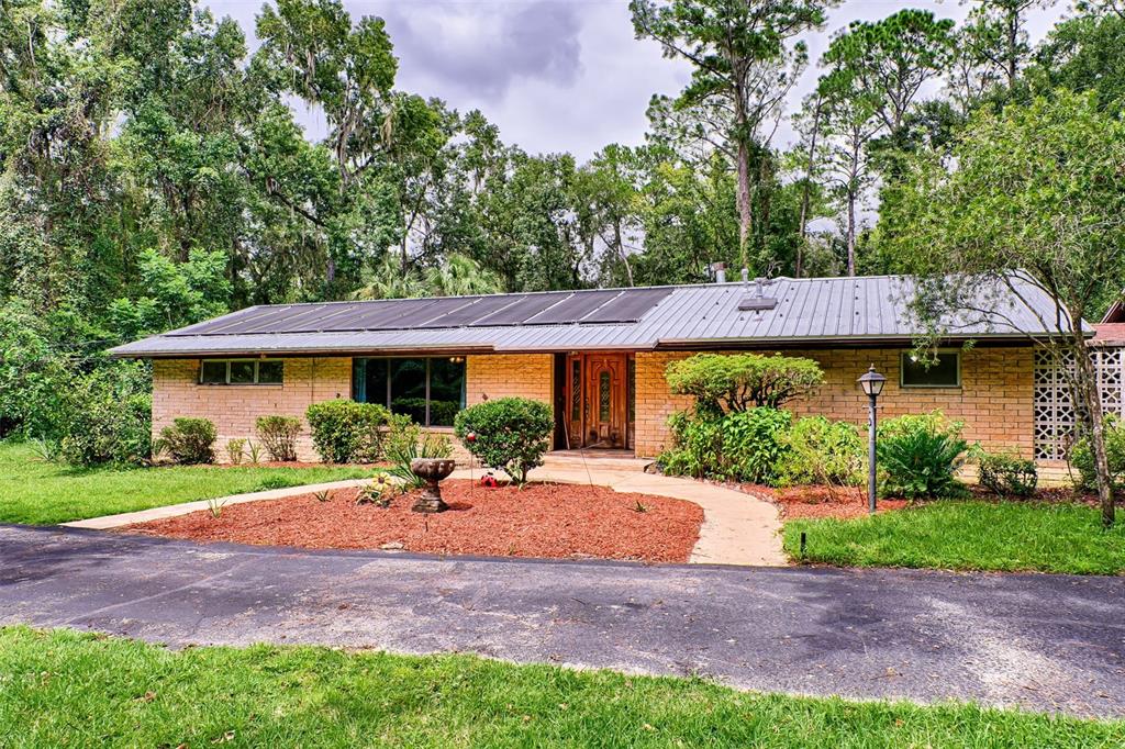 a front view of a house with garden