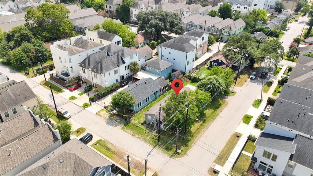 an aerial view of multiple houses with yard