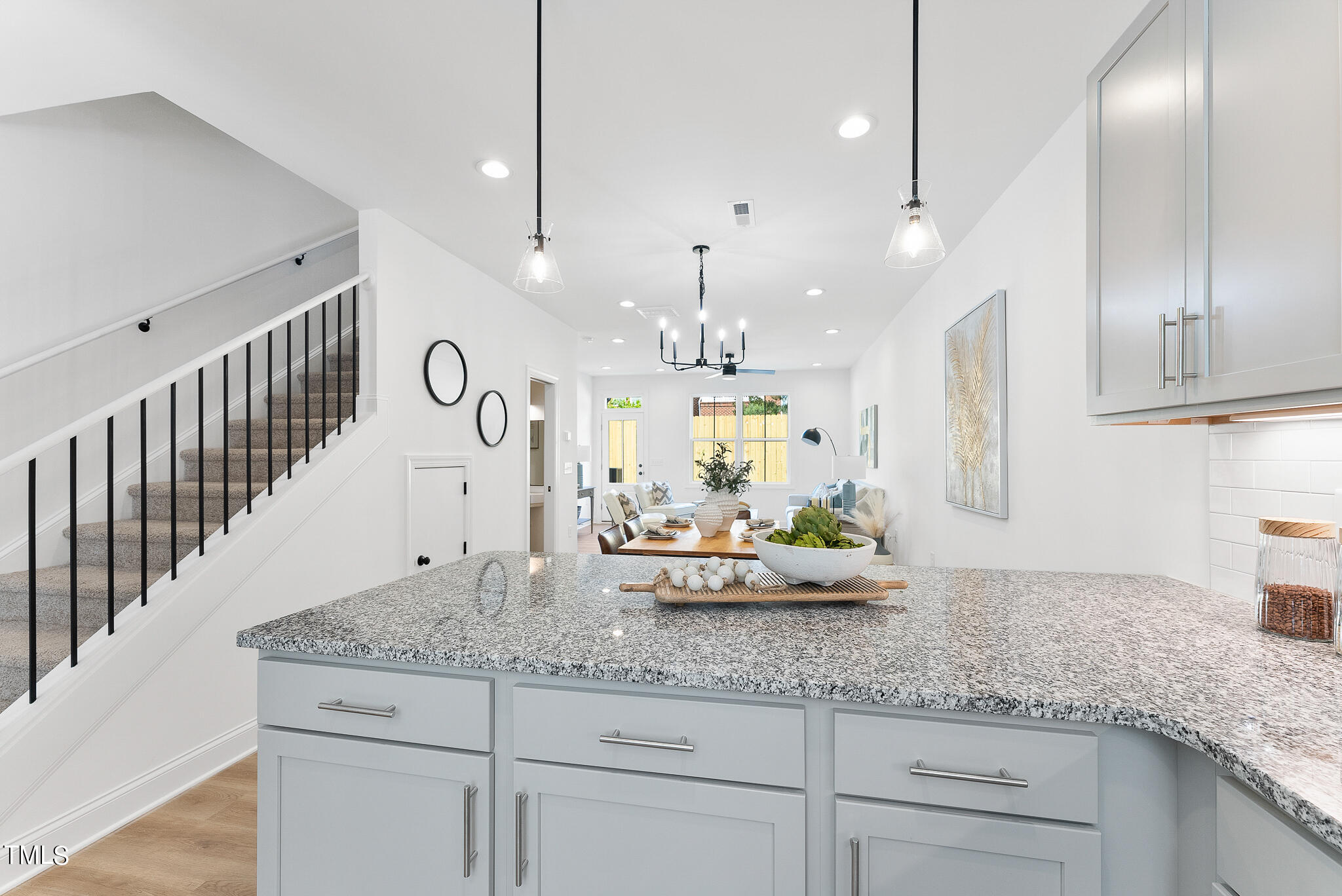 a kitchen with kitchen island white cabinets and sink