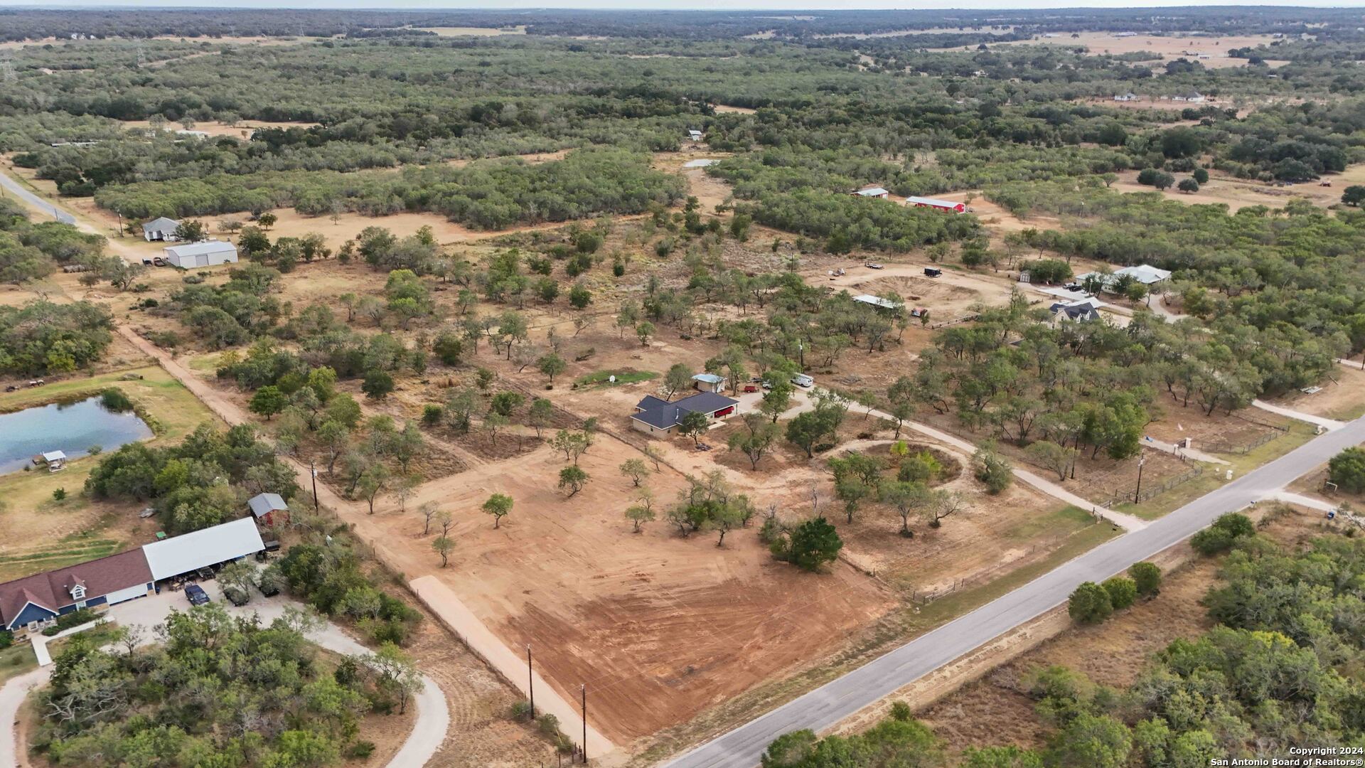 an aerial view of residential houses with outdoor space