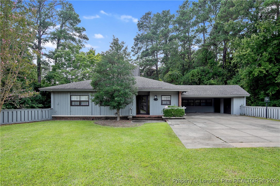 a view of a house with a yard and tree s