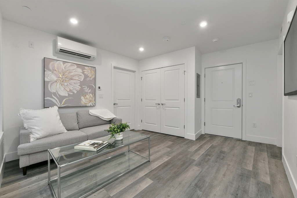 a living room with furniture and a hard wood floor