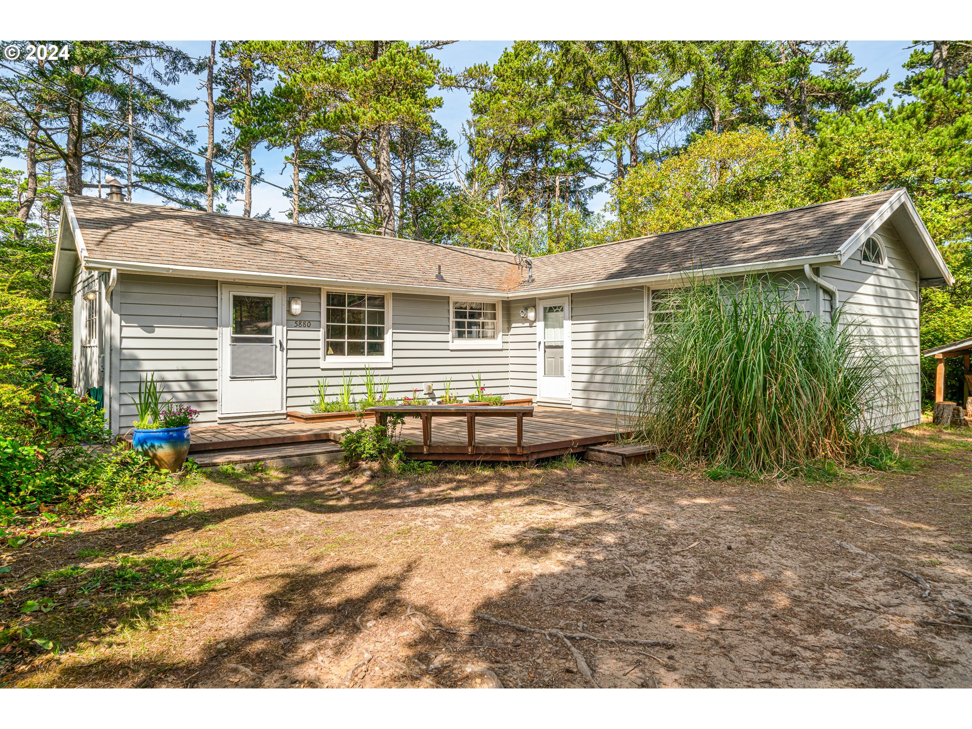 a view of house with backyard and outdoor seating