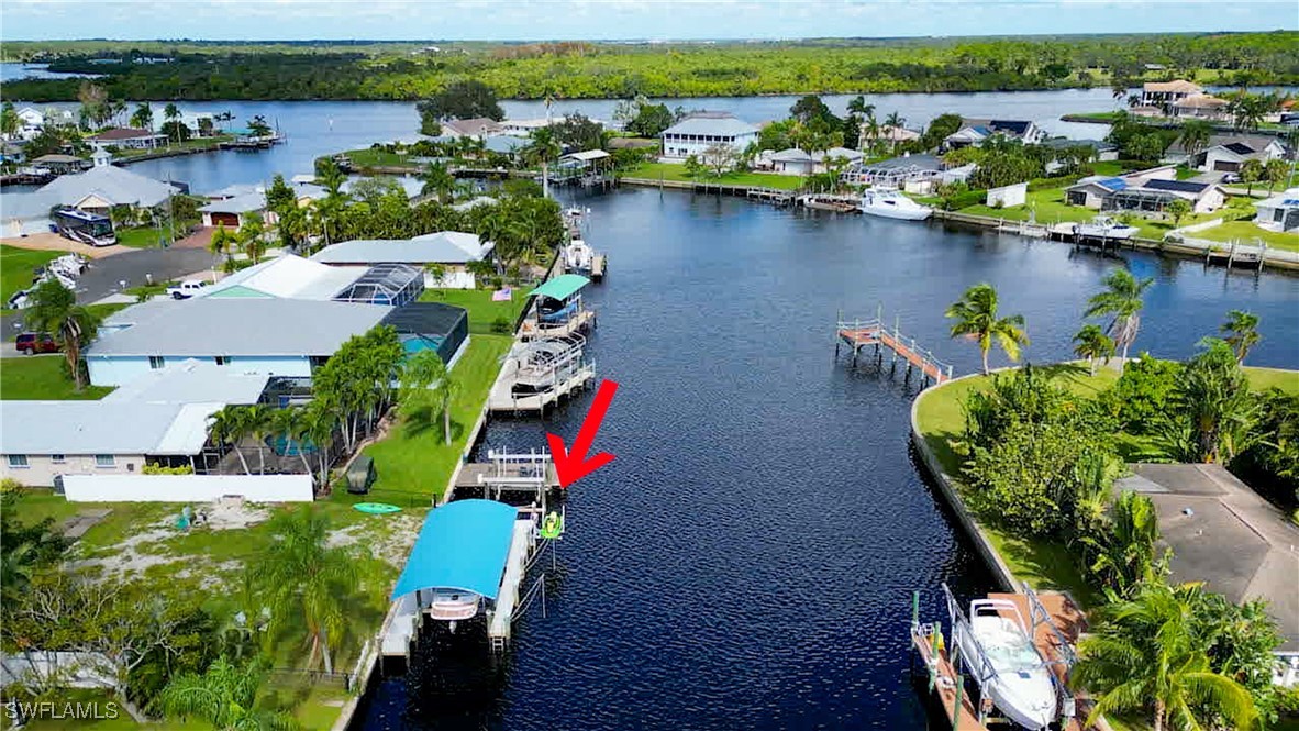 an aerial view of a house with a yard lake view and mountain view