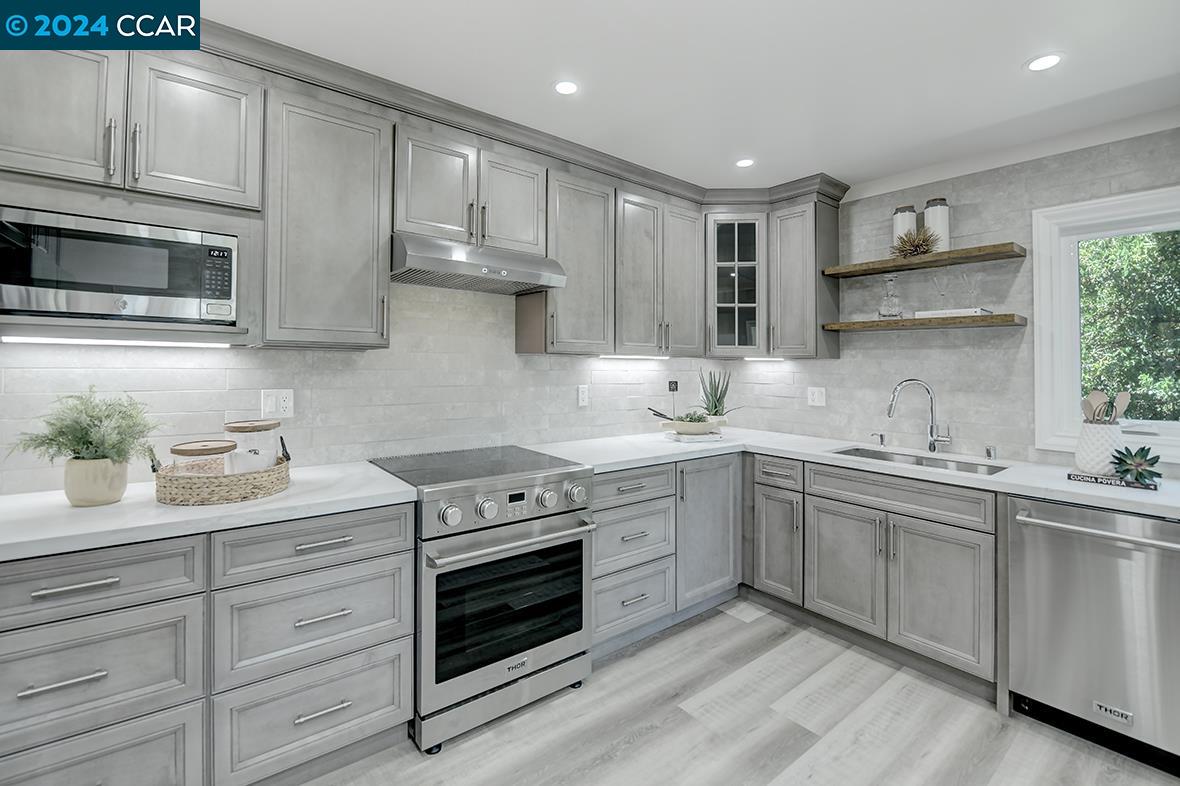 a kitchen with a sink stove and microwave