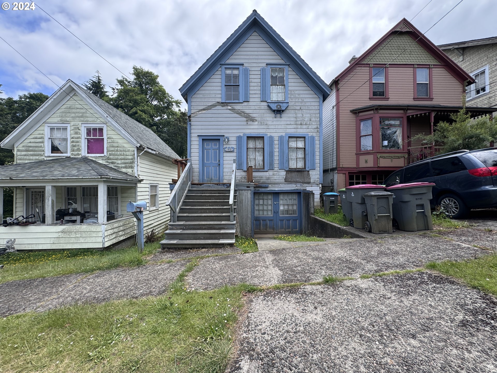 a view of a house with a yard and lawn chairs