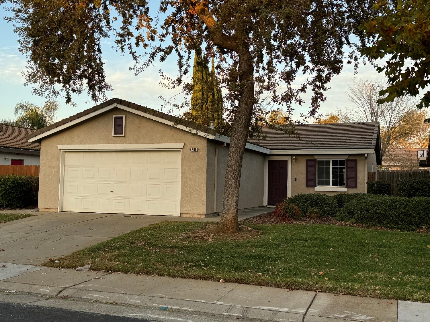 a front view of house with yard and trees