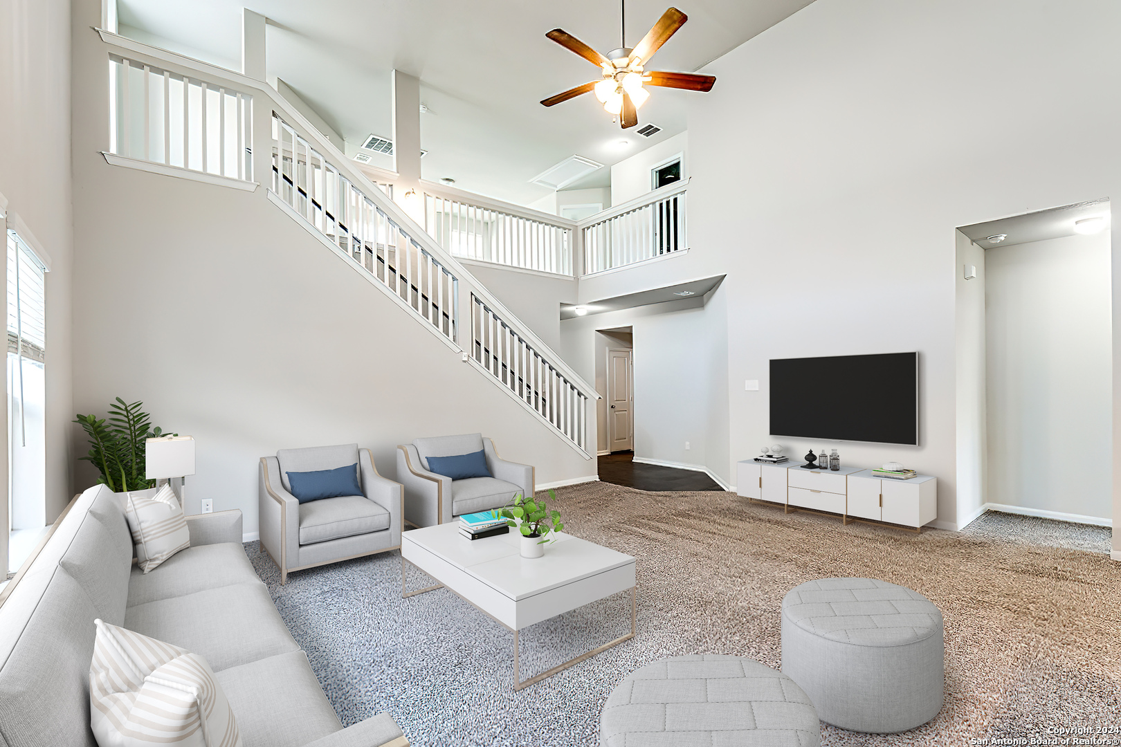 a living room with furniture and a flat screen tv