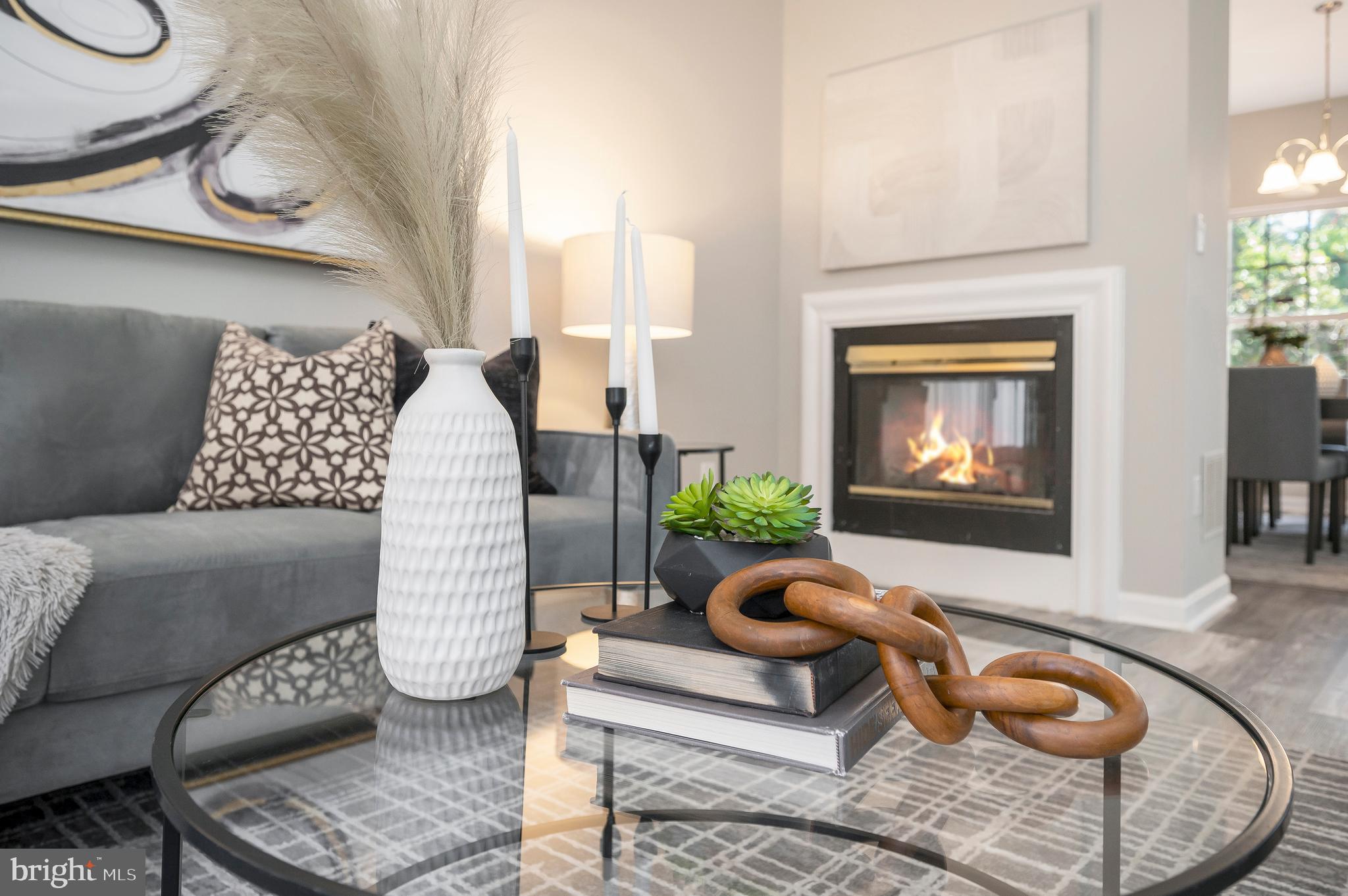 a living room with furniture chess board and a fireplace