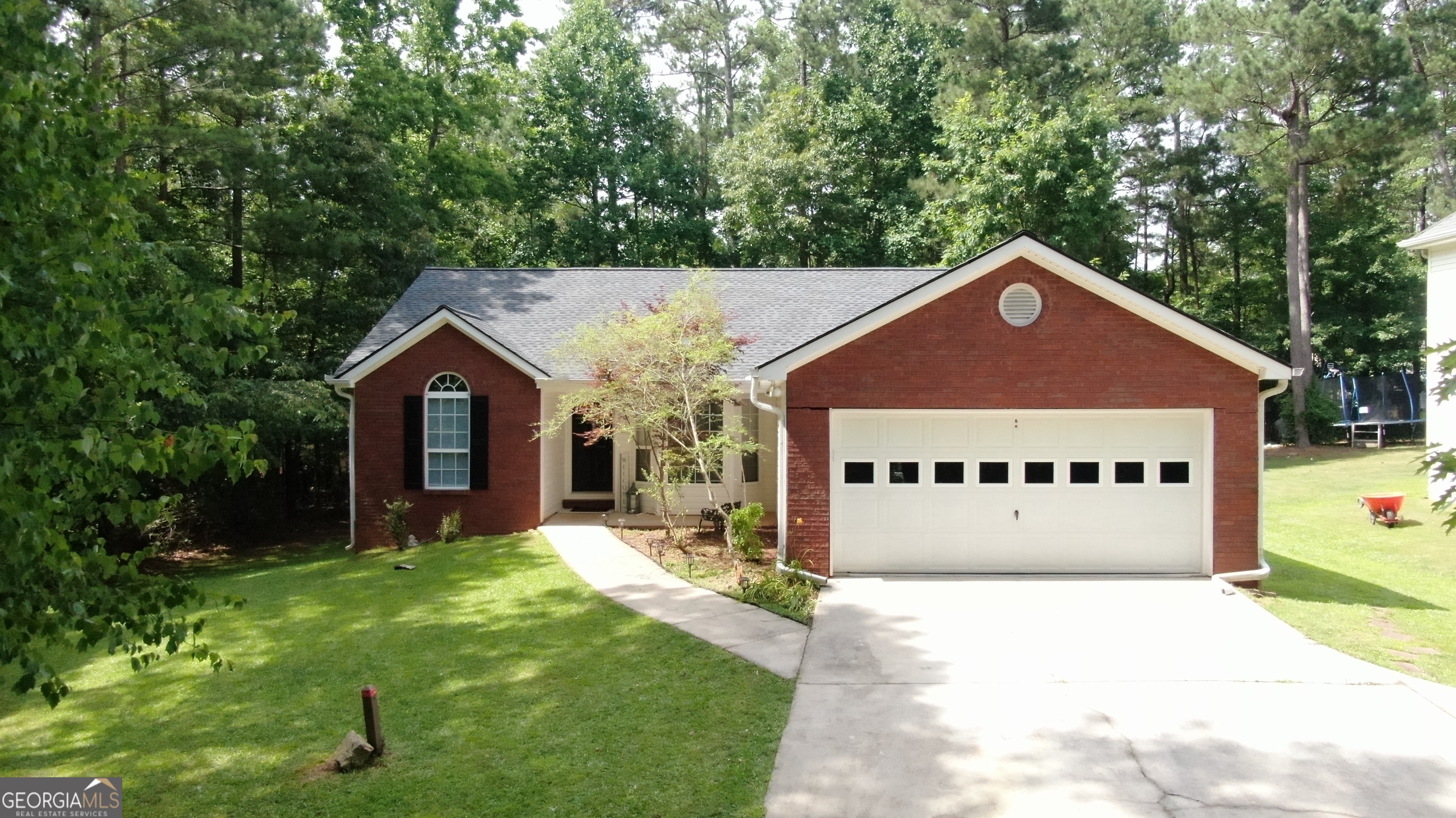 a front view of a house with a yard