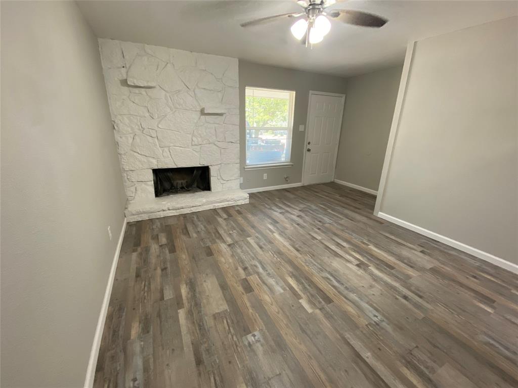 wooden floor in an empty room with a fireplace