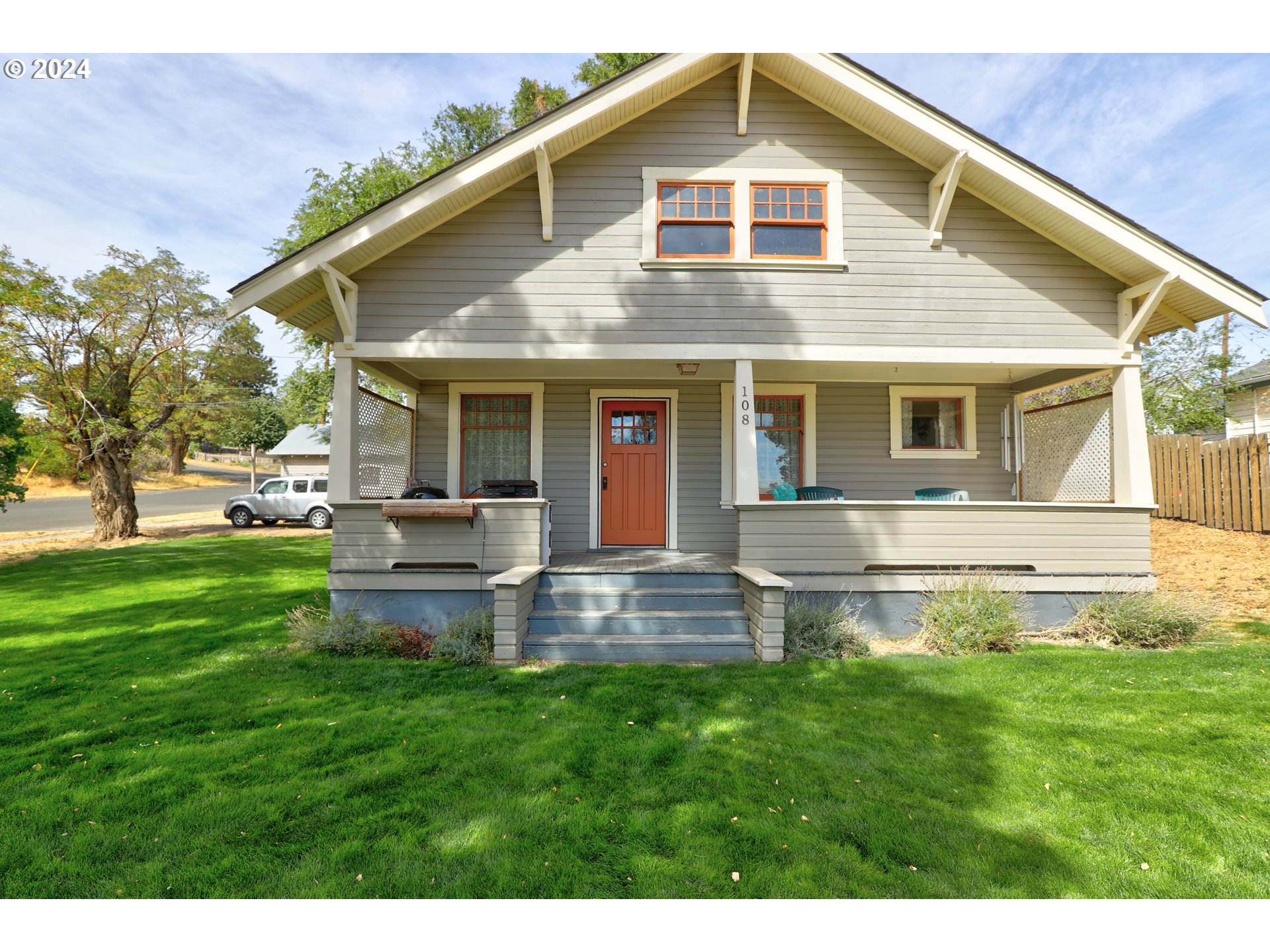 a front view of house with yard and outdoor seating