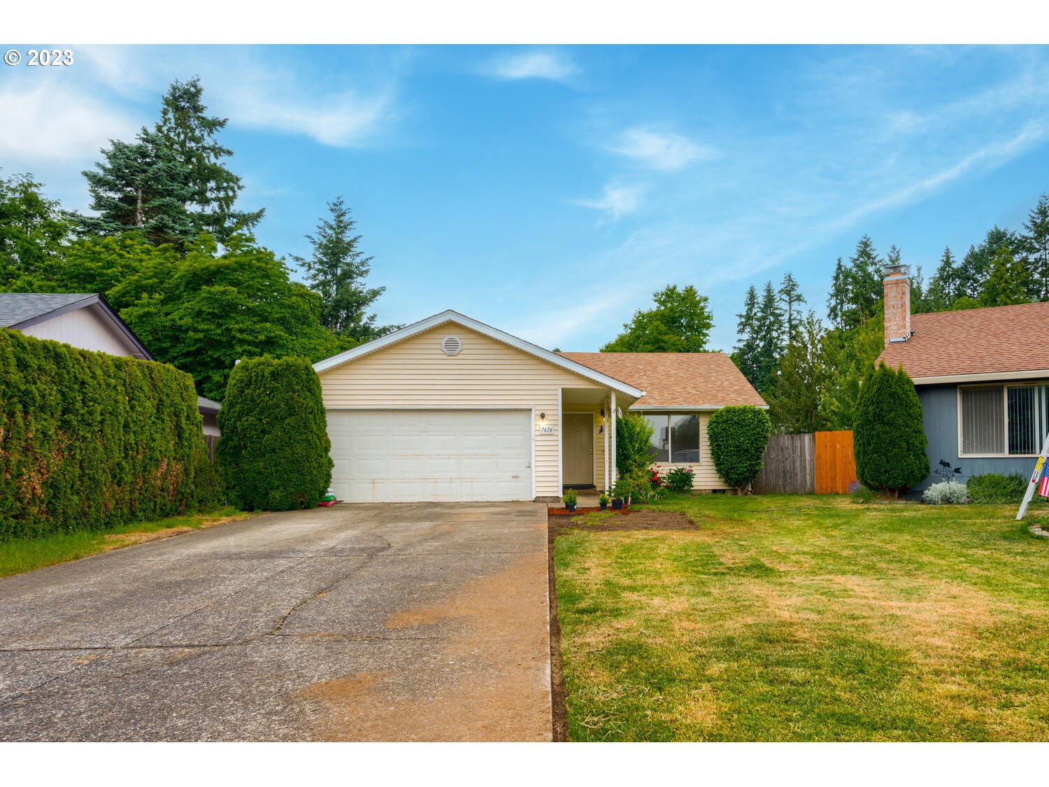 a view of a house with a yard and garage