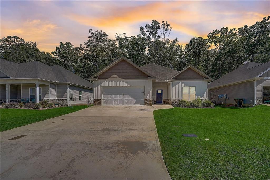 a front view of a house with a yard and garage